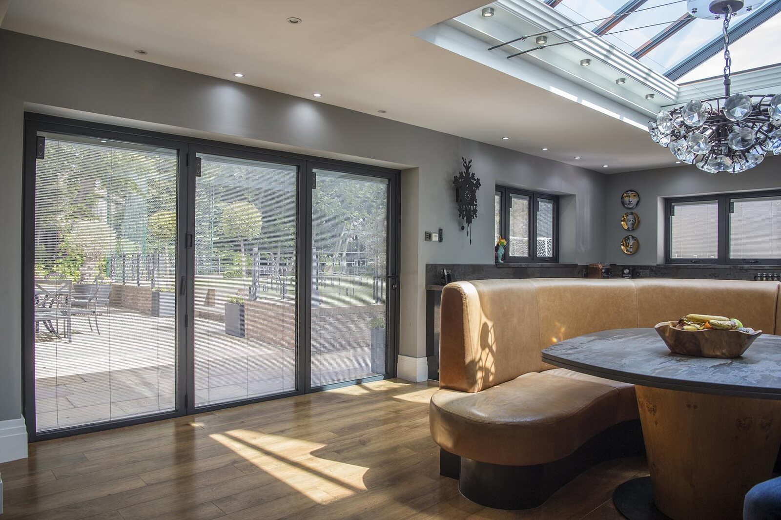 Integral blinds fitted inside dark framed bi-fold doors