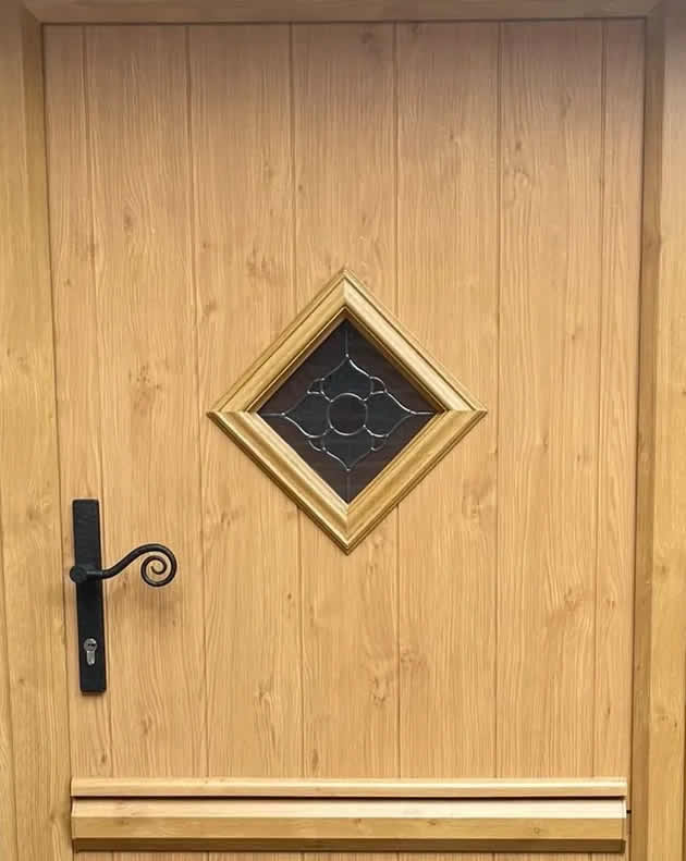 Cornwall Irish Oak composite stable door with black Monkey Tail handle in Bressingham