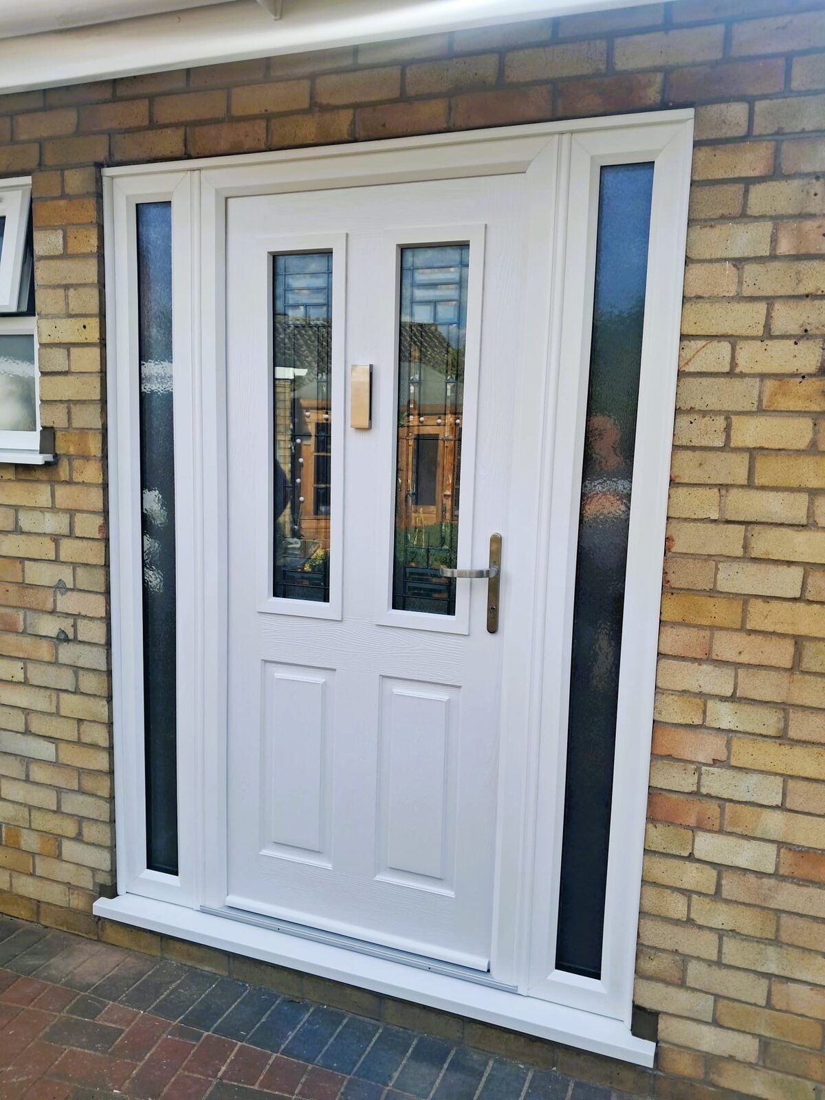 New composite front entrance door with adjoining glazed side panel in Diss