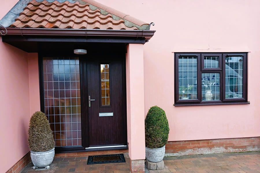 Rosewood-on-white uPVC windows and composite front door installed in Haughley Green