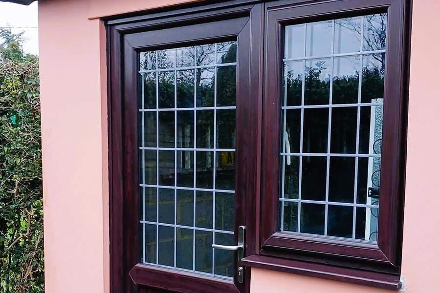 Rosewood-on-white uPVC windows with leaded glazing