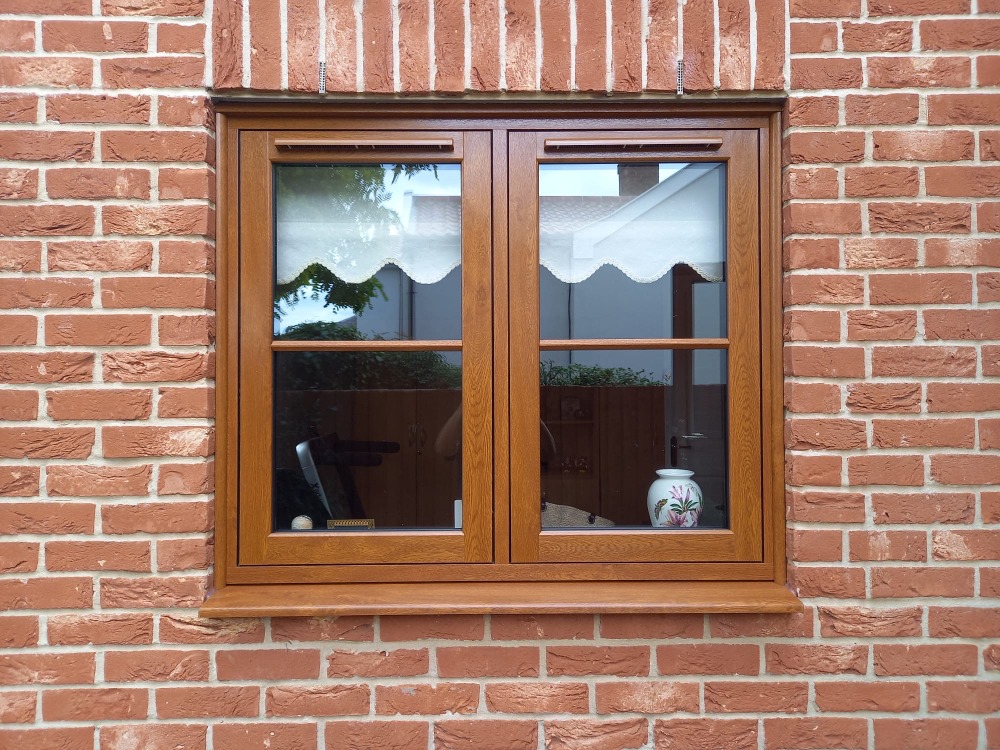 Golden Oak uPVC flush casement windows with fully mechanical joints.