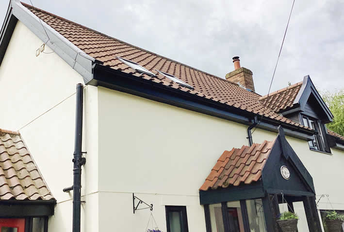 Black uPVC roofline, cladding and windows fitted in Thorndon